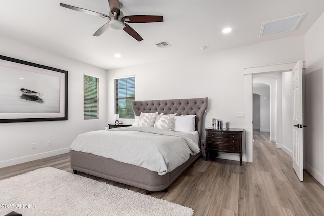 2985 N Point Ridge Rd, Buckeye, AZ 85396 - bedroom with arched walkways, wood finished floors, baseboards, recessed lighting, and a ceiling fan