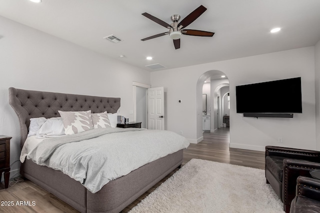2985 N Point Ridge Rd, Buckeye, AZ 85396 - bedroom featuring arched walkways, wood finished floors, baseboards, recessed lighting, and a ceiling fan