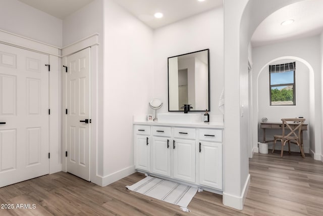 2985 N Point Ridge Rd, Buckeye, AZ 85396 - bathroom with wood finished floors, baseboards, vanity, and recessed lighting
