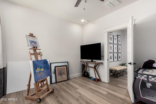 2985 N Point Ridge Rd, Buckeye, AZ 85396 - living area featuring wood finished floors, a ceiling fan, and baseboards