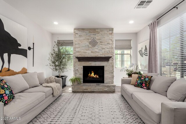 2985 N Point Ridge Rd, Buckeye, AZ 85396 - living room featuring healthy amount of natural light, a stone fireplace, and recessed lighting