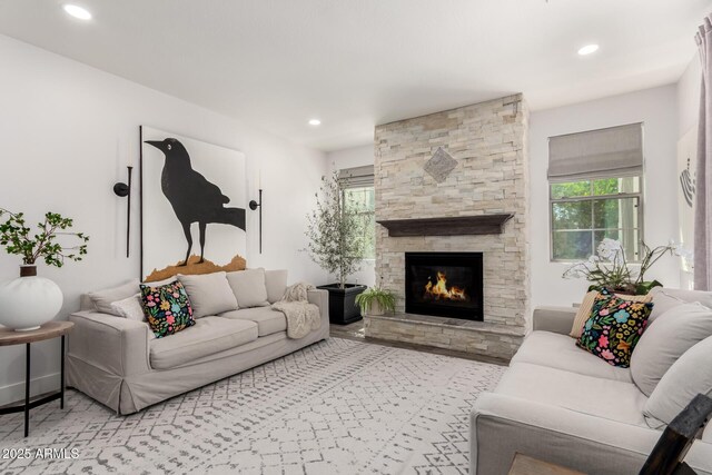 2985 N Point Ridge Rd, Buckeye, AZ 85396 - living room featuring a stone fireplace, plenty of natural light, and recessed lighting