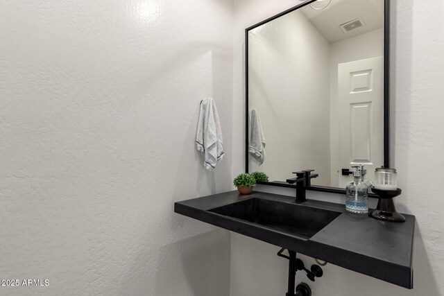 2985 N Point Ridge Rd, Buckeye, AZ 85396 - bathroom featuring a textured wall and a sink