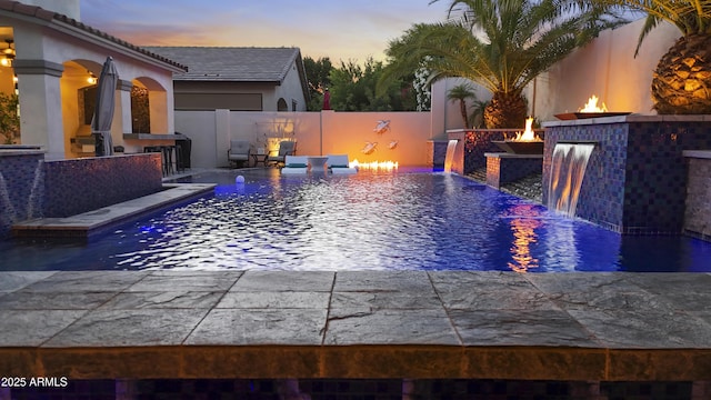 2985 N Point Ridge Rd, Buckeye, AZ 85396 - view of pool with a patio, an outdoor fire pit, an outdoor bar, and a fenced backyard