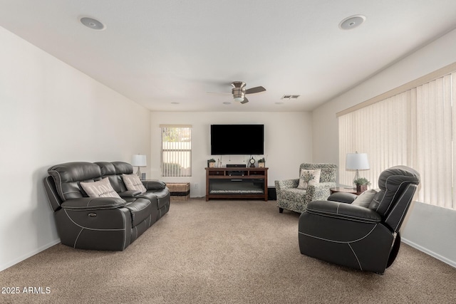 carpeted living room featuring a ceiling fan, baseboards, and visible vents