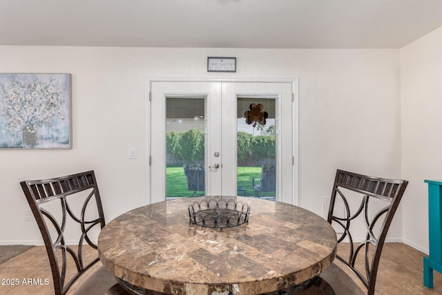 dining area with french doors and baseboards