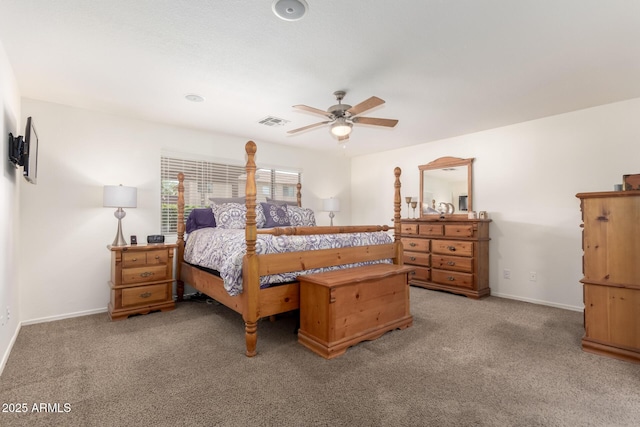 carpeted bedroom with visible vents, baseboards, and ceiling fan