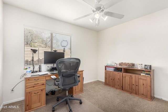 office with baseboards, light carpet, and ceiling fan