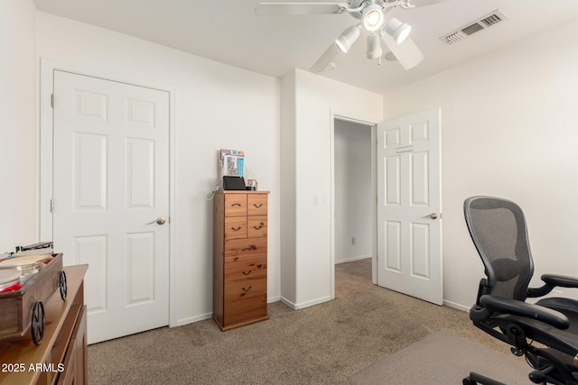 office area featuring baseboards, light colored carpet, visible vents, and ceiling fan