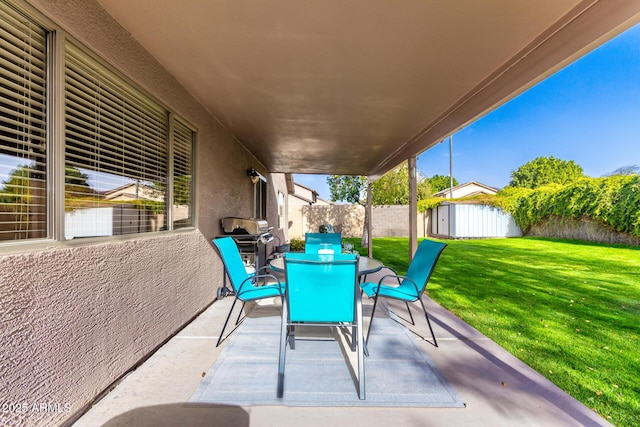 view of patio / terrace featuring an outdoor structure, a fenced backyard, and a shed