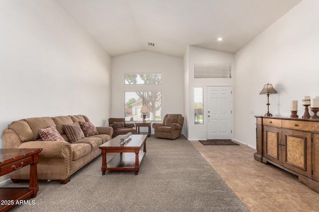 living room with baseboards and high vaulted ceiling