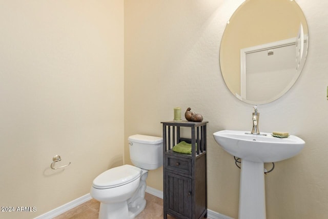 bathroom with tile patterned floors and toilet