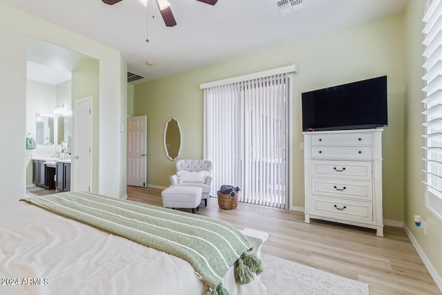 bedroom with connected bathroom, ceiling fan, multiple windows, and light hardwood / wood-style floors