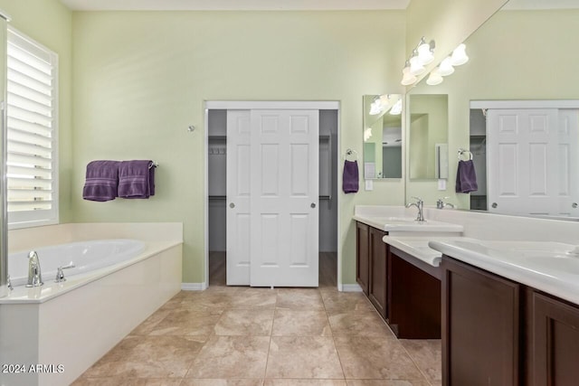 bathroom with vanity, tile patterned flooring, and a washtub