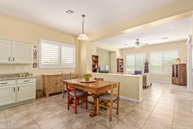 dining room with light tile patterned floors and ceiling fan