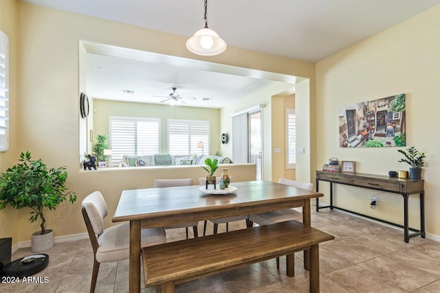 tiled dining area featuring ceiling fan