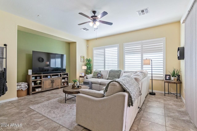 tiled living room with ceiling fan