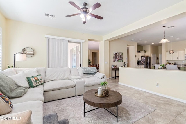 tiled living room with ceiling fan