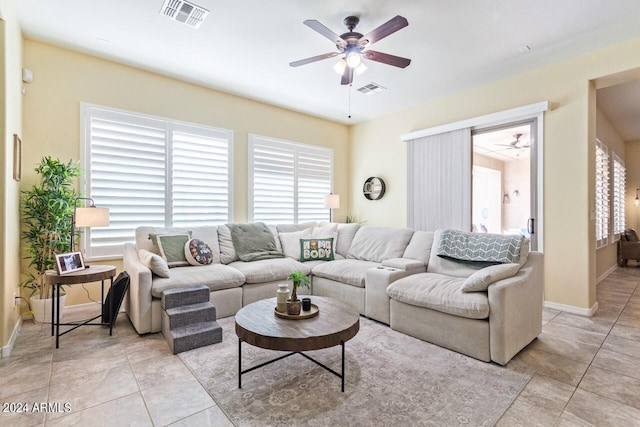 living room featuring light tile patterned floors and ceiling fan