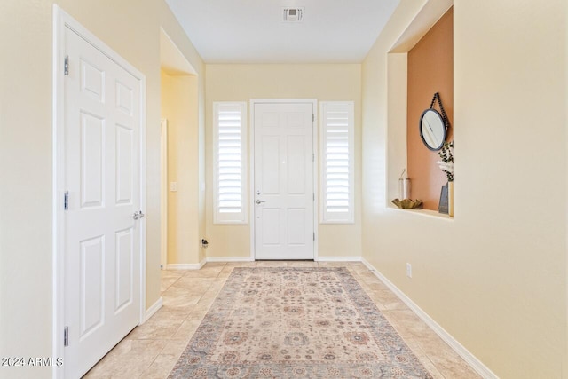 foyer entrance with light tile patterned floors