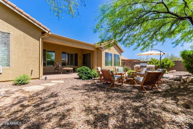 exterior space featuring an outdoor fire pit and a patio