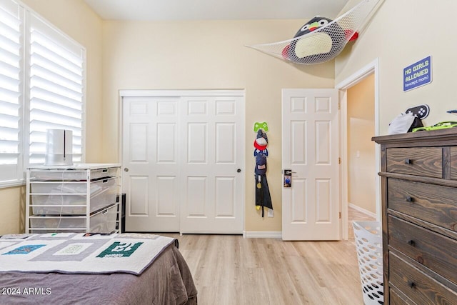 bedroom with a closet and light wood-type flooring