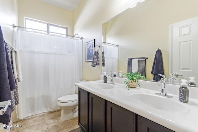 bathroom with curtained shower, tile patterned flooring, vanity, and toilet