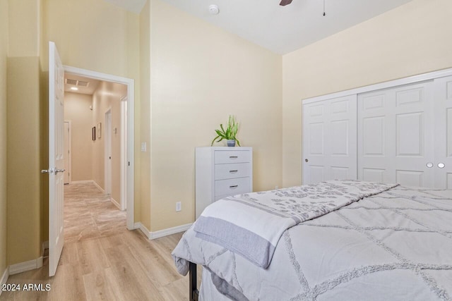 bedroom with a closet, ceiling fan, and light hardwood / wood-style floors