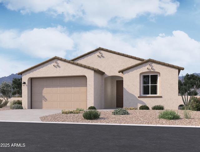 mediterranean / spanish home featuring a garage, concrete driveway, a tile roof, and stucco siding