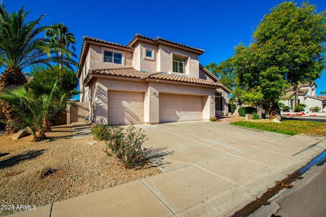 mediterranean / spanish-style home with a garage