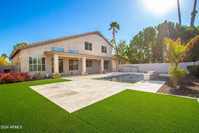 back of house featuring a patio area, a fenced in pool, and a yard