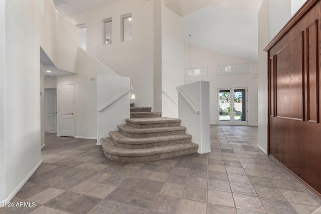 staircase with a towering ceiling