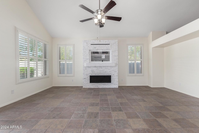 unfurnished living room with a fireplace, lofted ceiling, and ceiling fan