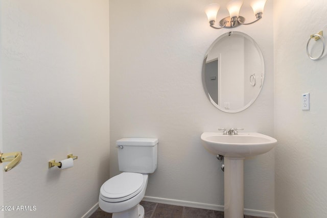 bathroom featuring sink, toilet, and hardwood / wood-style flooring