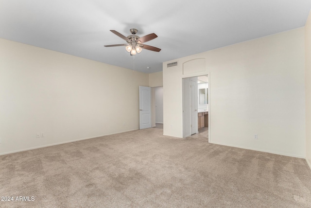 unfurnished room featuring light colored carpet and ceiling fan