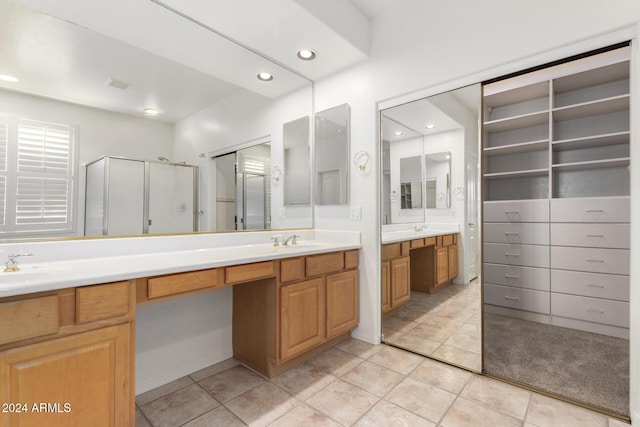 bathroom featuring tile patterned floors, vanity, and an enclosed shower