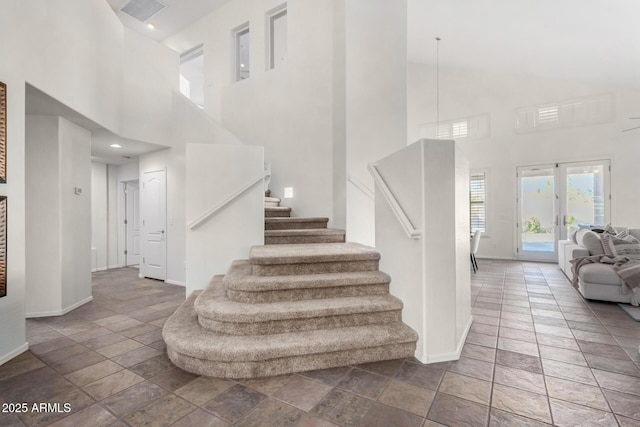 stairway featuring a high ceiling