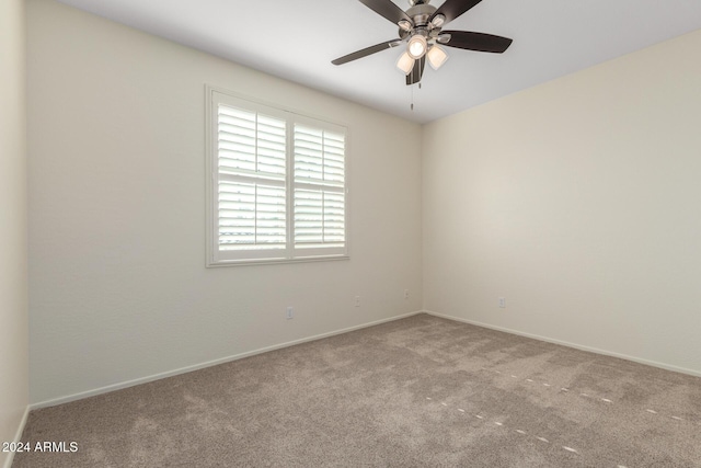 spare room with ceiling fan and light colored carpet