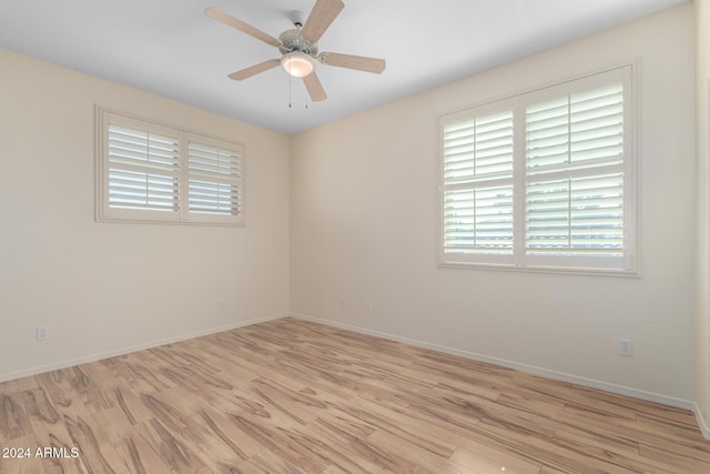 empty room with light wood-type flooring and ceiling fan