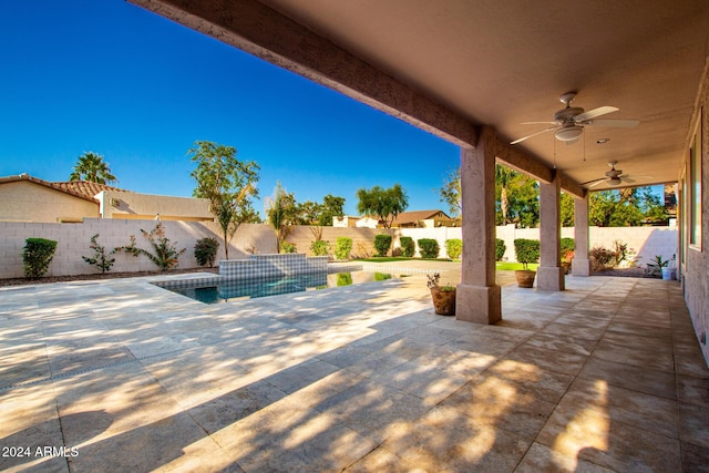 view of swimming pool featuring ceiling fan and a patio area