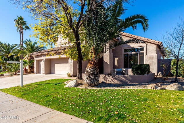 view of front facade featuring a garage and a front lawn