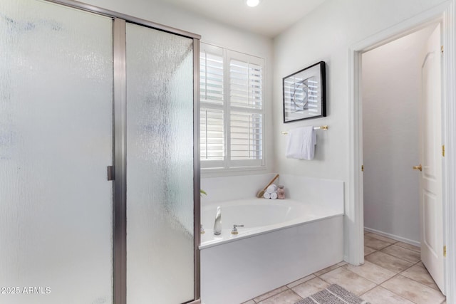 bathroom with independent shower and bath and tile patterned flooring