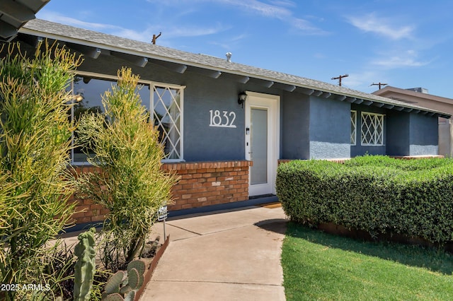 1832 E Concorda Dr, Tempe, AZ 85282 - view of exterior entry featuring stucco siding and a shingled roof