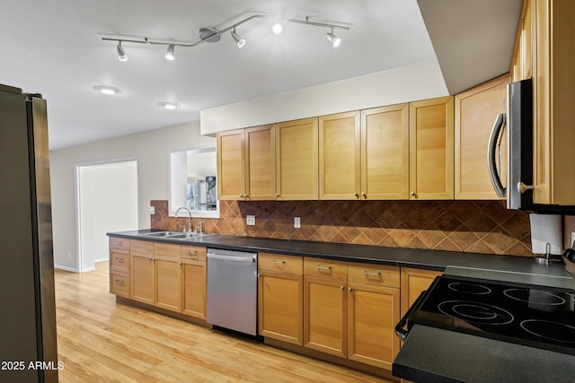 1832 E Concorda Dr, Tempe, AZ 85282 - kitchen with appliances with stainless steel finishes, a sink, dark countertops, light wood-style floors, and tasteful backsplash