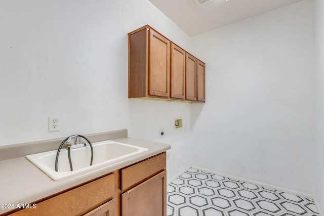 washroom with electric dryer hookup, washer hookup, a sink, cabinet space, and light floors