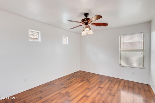 unfurnished room with baseboards, a ceiling fan, and wood finished floors