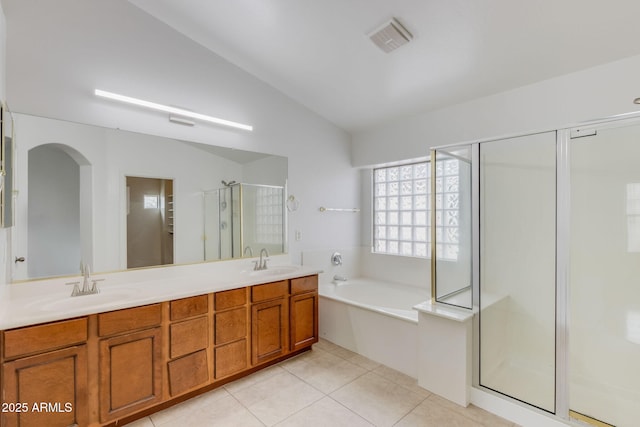 full bath with a garden tub, lofted ceiling, a stall shower, a sink, and tile patterned floors