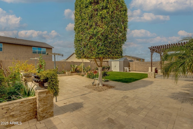 view of patio / terrace with a storage shed, an outbuilding, a fenced backyard, and a pergola