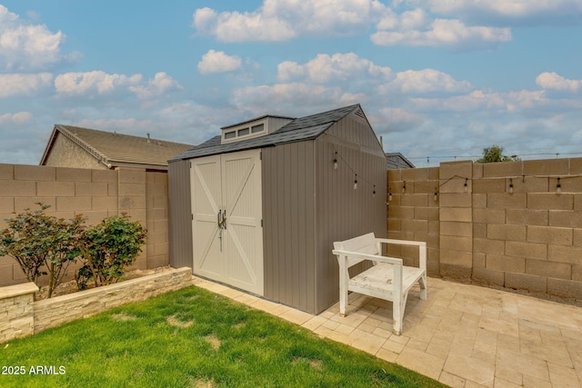 view of shed with a fenced backyard