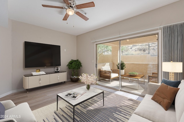 living room featuring ceiling fan and light hardwood / wood-style flooring